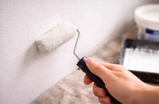 Priming and painting a patched wall area for a seamless finish