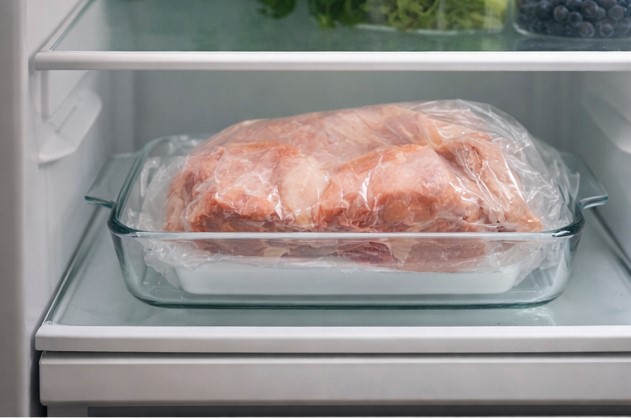 Thawing meat safely in the fridge on the bottom shelf